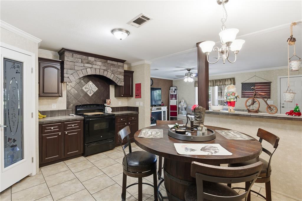 4506 Northwest 10th Street Bell, FL 32619 - Photo 39 of 50 a kitchen with a dining table and chairs
