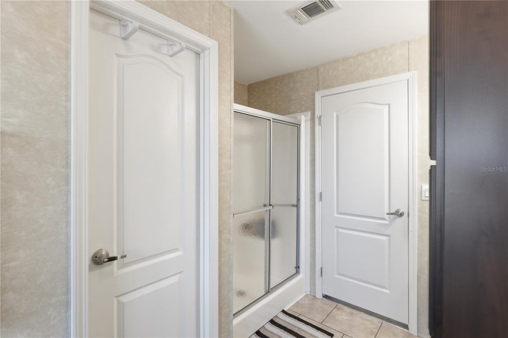 4506 Northwest 10th Street Bell, FL 32619 - Photo 46 of 50 a bathroom with a glass shower door