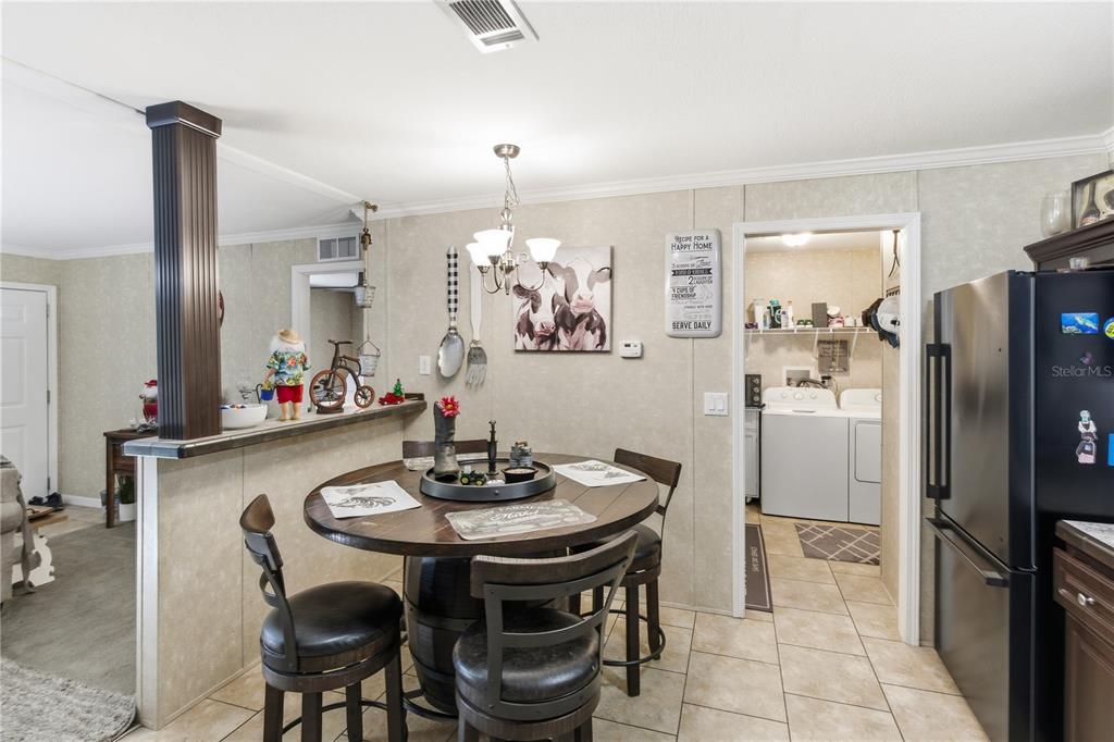 4506 Northwest 10th Street Bell, FL 32619 - Photo 48 of 50 a kitchen with a dining table and chairs