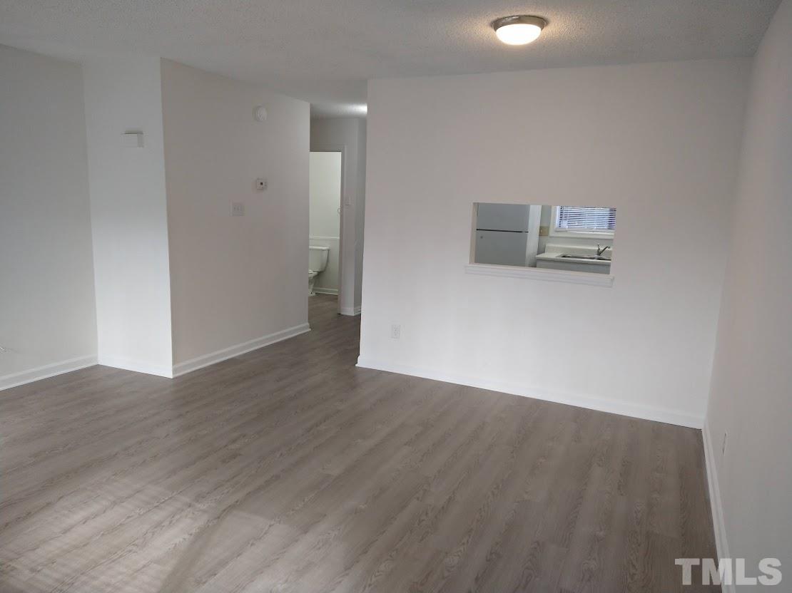 4240 Lake Ridge Drive, Unit 4240 Raleigh, NC 27604 - Photo 8 of 20 a view of a room with wooden floor