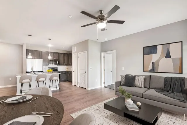 a living room with furniture and kitchen view