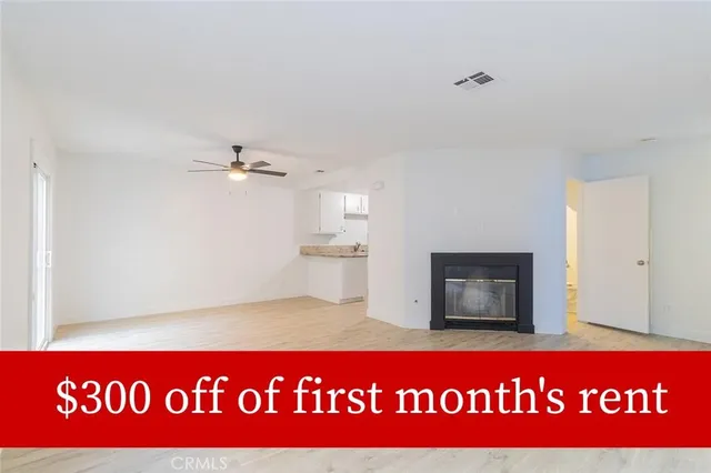 a view of a kitchen with a refrigerator a microwave and a sink