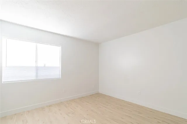 a bathroom with a granite countertop toilet sink and mirror