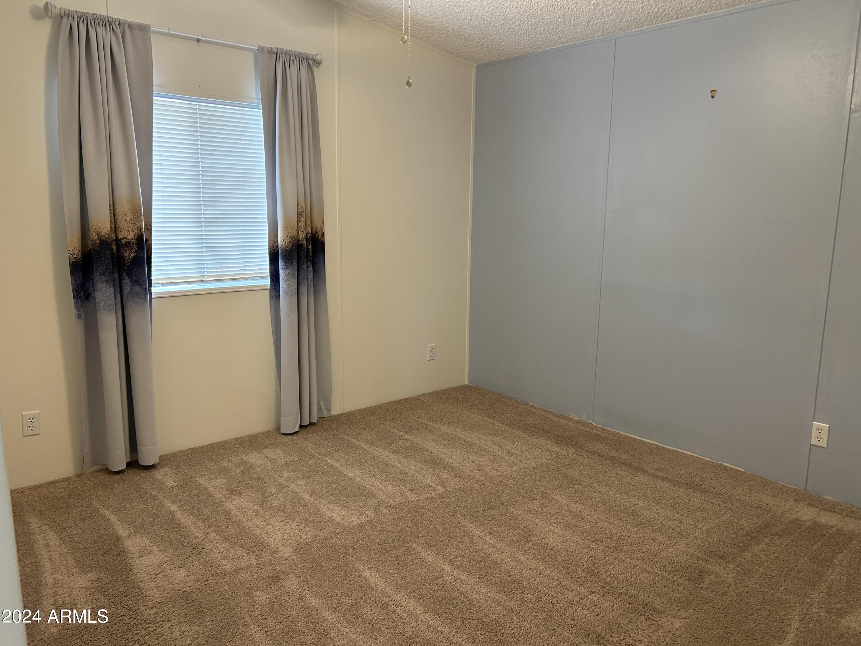 301 South Signal Butte Road, Unit 938 Apache Junction, AZ 85120 - Photo 10 of 11 a view of an empty room with a window
