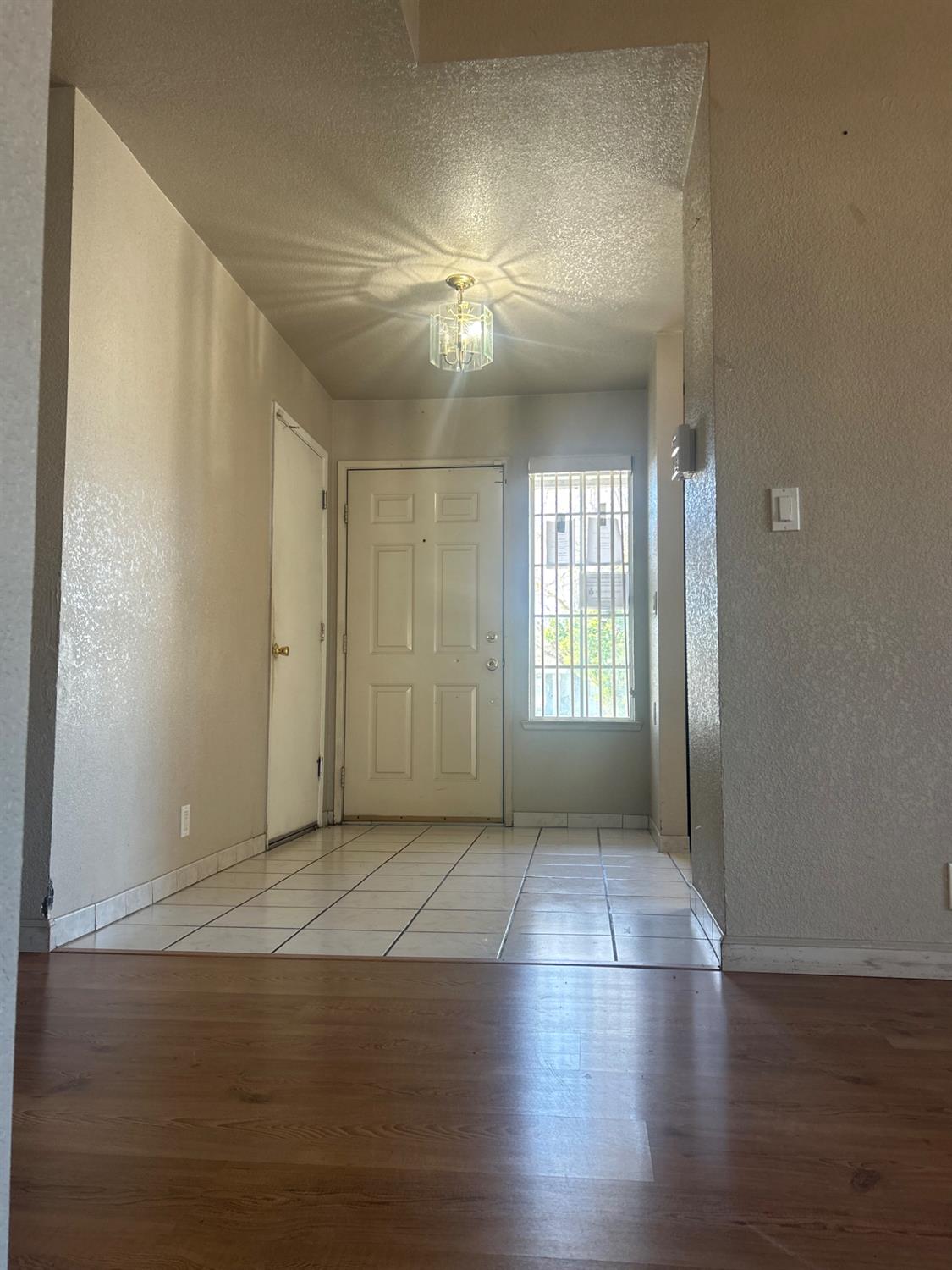 3421 Penny Lane Modesto, CA 95354 - Photo 6 of 12 an empty room with wooden floor and windows