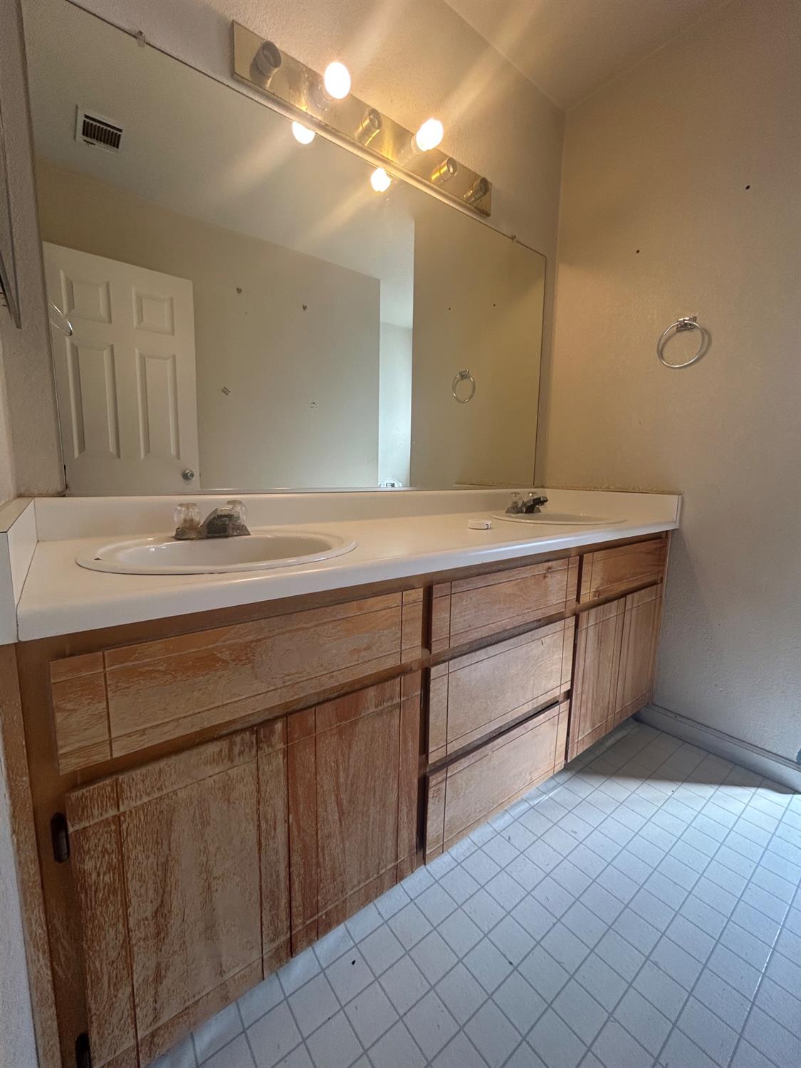 3421 Penny Lane Modesto, CA 95354 - Photo 7 of 12 a bathroom with a sink vanity and mirror