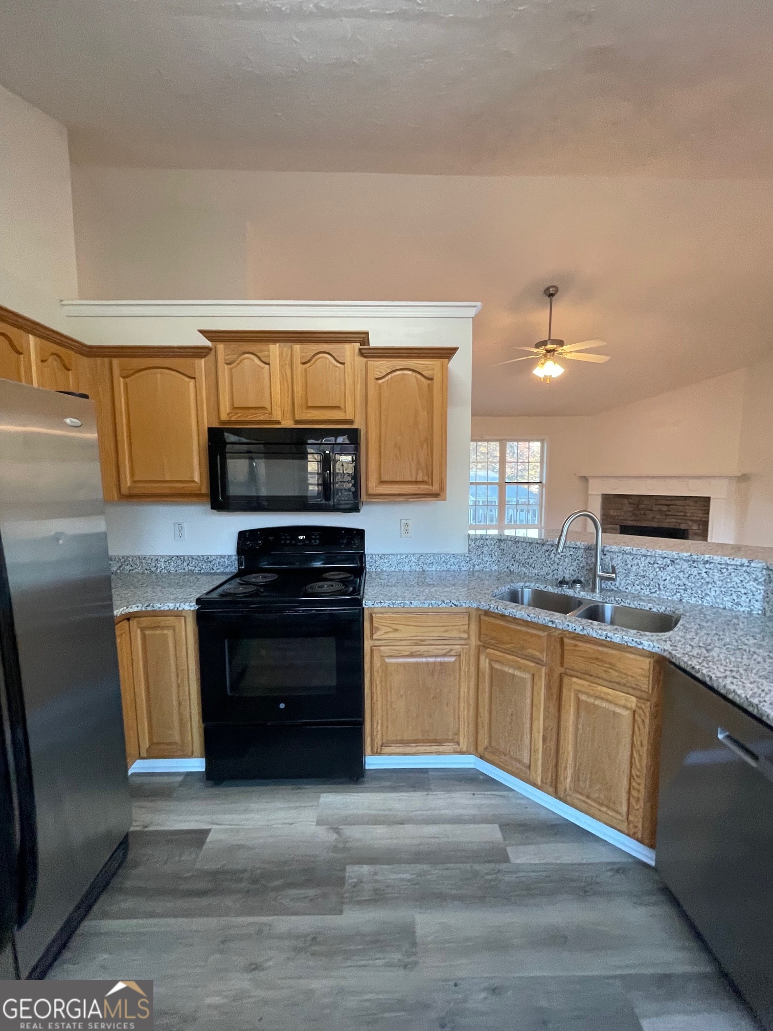 721 Meadow Spring Drive Temple, GA 30179 - Photo 12 of 43 a kitchen with granite countertop a stove top oven and sink
