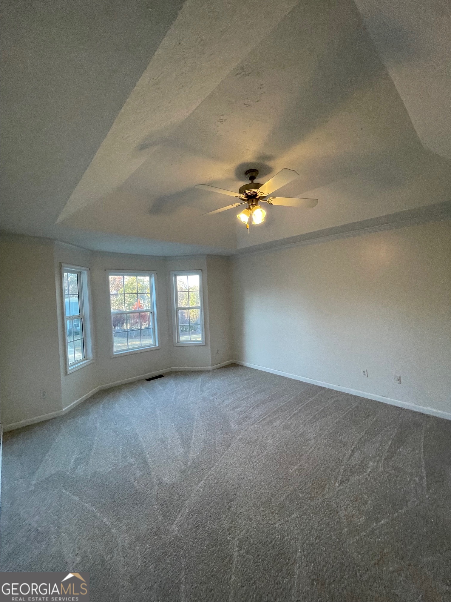 721 Meadow Spring Drive Temple, GA 30179 - Photo 15 of 43 an empty room with windows and chandelier fan