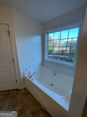 a bathroom with a bathtub and window