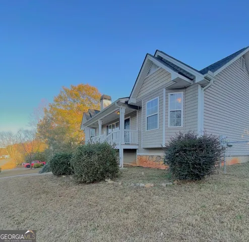 a house that has a tree in front of it