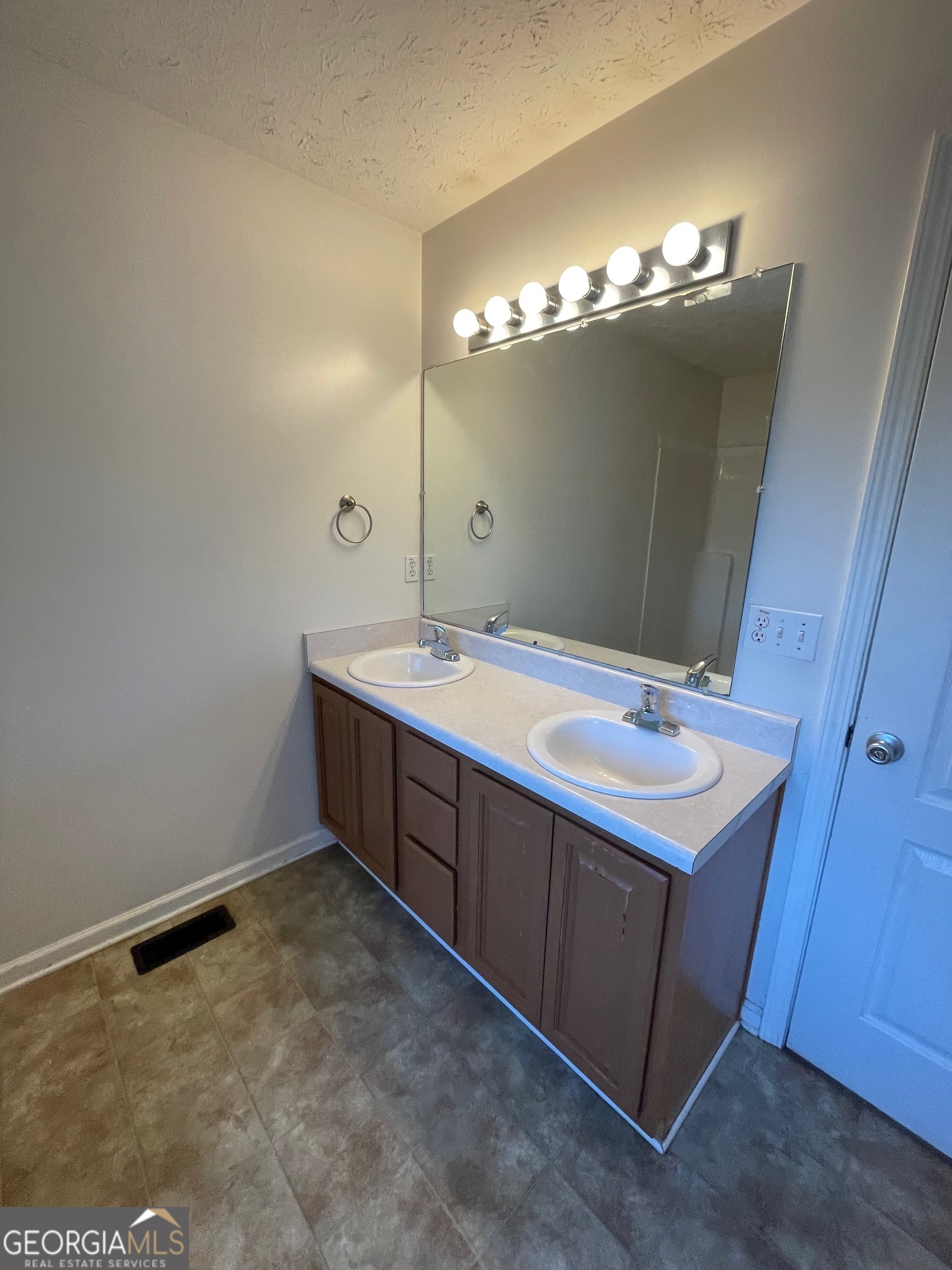 721 Meadow Spring Drive Temple, GA 30179 - Photo 24 of 43 a bathroom with a double vanity sink and a mirror