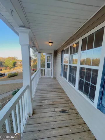 a view of balcony with wooden floor and fence