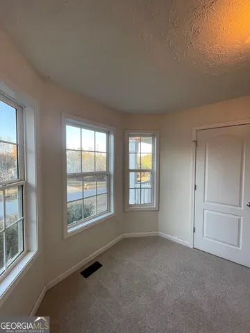 a view of an empty room and closet area