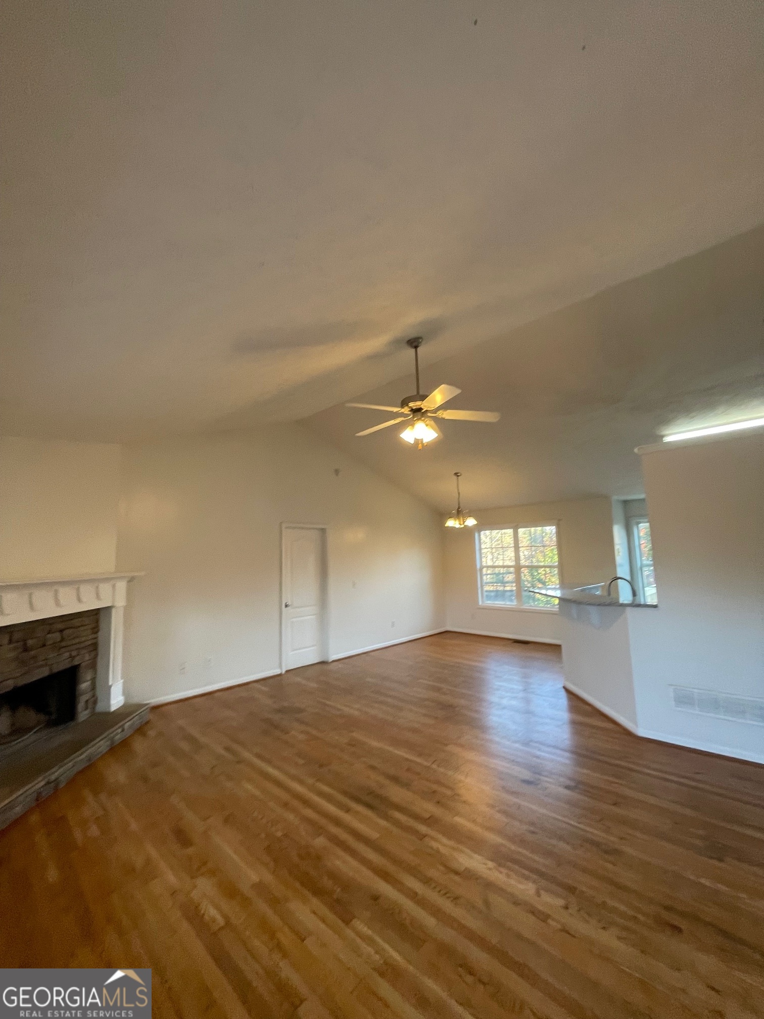 721 Meadow Spring Drive Temple, GA 30179 - Photo 7 of 43 a view of empty room with wooden floor and fireplace