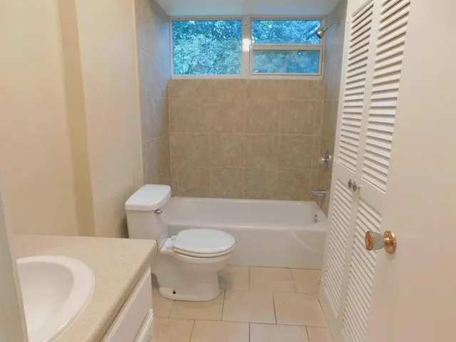a bathroom with a toilet and a bathtub