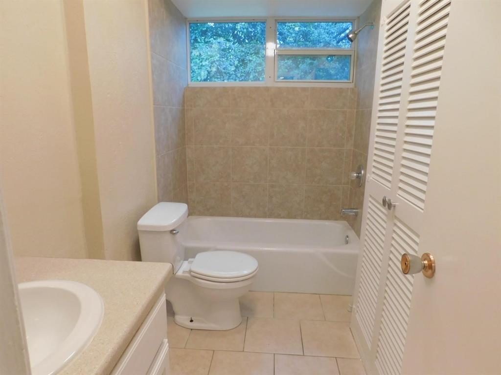 1301 Doncaster Street Irving, TX 75062 - Photo 14 of 19 a bathroom with a toilet and a bathtub