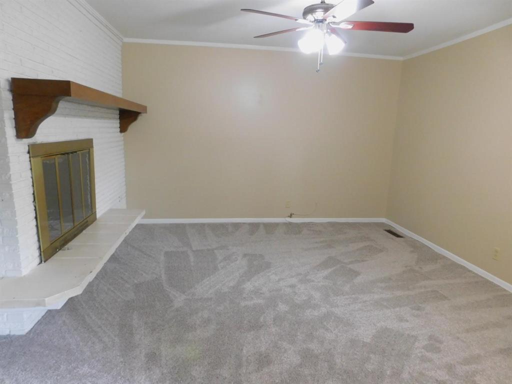 1301 Doncaster Street Irving, TX 75062 - Photo 3 of 19 an empty room with a chandelier fan and windows