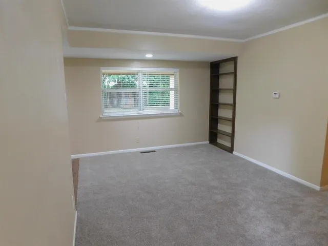 an empty room with windows and closet