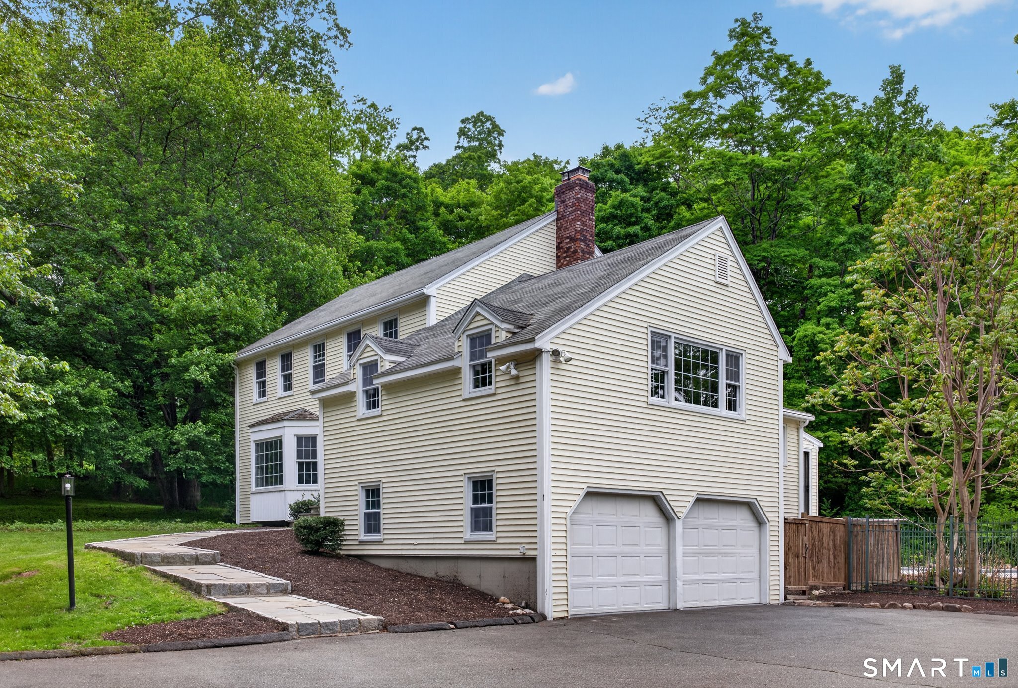 70 Barrack Hill Road Ridgefield, CT 06877 - Photo 20 of 32 a view of a white house with a small yard and large tree