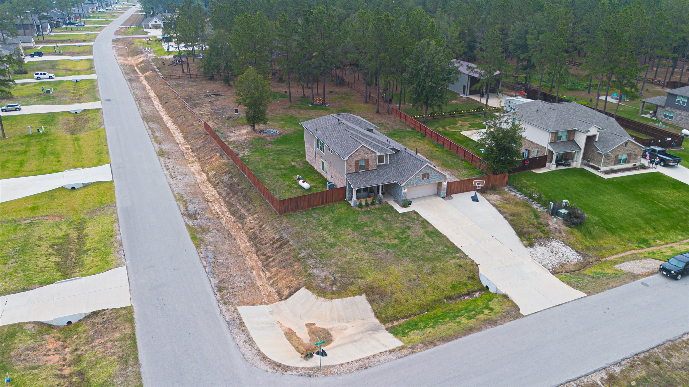16601 Crosby Street Conroe, TX 77303 - Photo 47 of 50 Aerial view highlighting the spacious lot, long driveway, and private fenced yard, all located in a peaceful, well-maintained neighborhood.