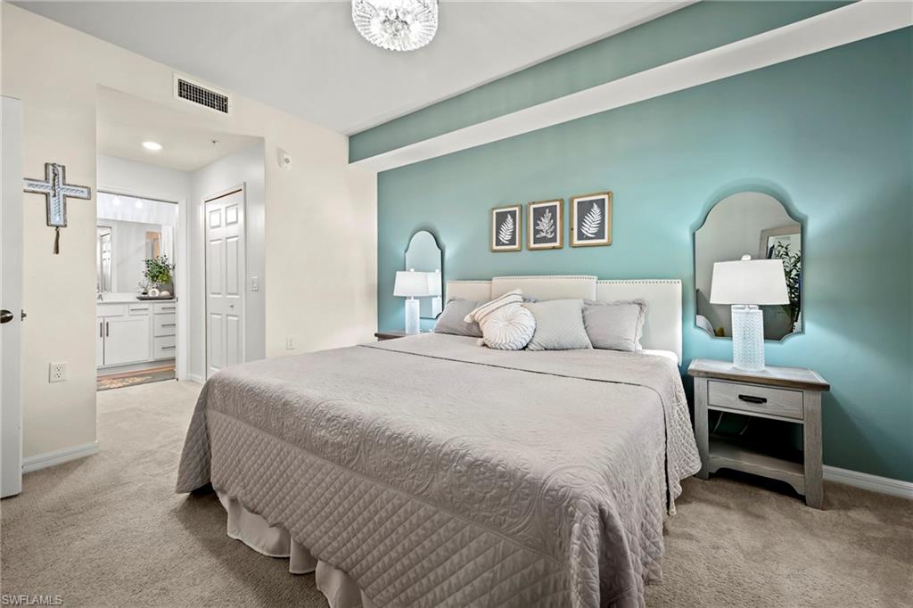 43993 Boardwalk Loop, Unit 1915 Babcock Ranch, FL 33982 - Photo 12 of 26 a bedroom with a bed and a table