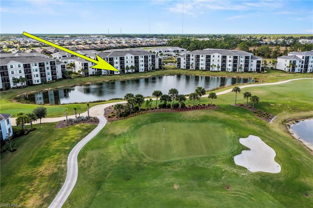 43993 Boardwalk Loop, Unit 1915 Babcock Ranch, FL 33982 - Photo 22 of 26 a view of a lake with a building and outdoor space