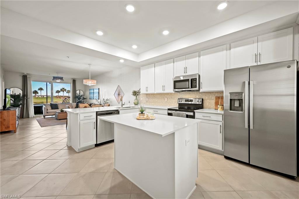 43993 Boardwalk Loop, Unit 1915 Babcock Ranch, FL 33982 - Photo 3 of 26 a kitchen with cabinets stainless steel appliances and a counter top space