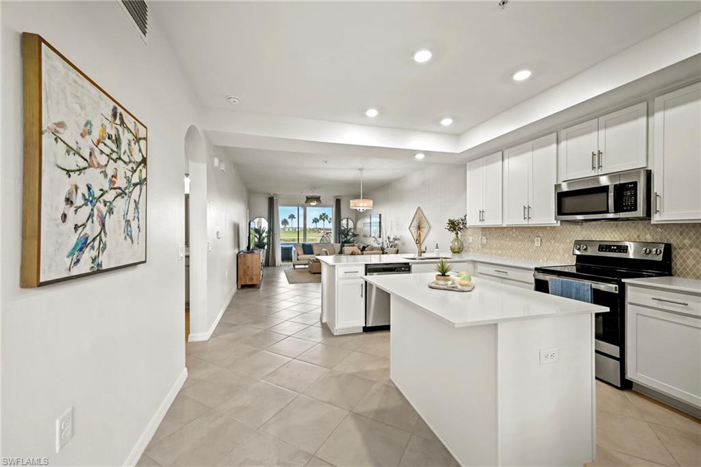 43993 Boardwalk Loop, Unit 1915 Babcock Ranch, FL 33982 - Photo 5 of 26 a kitchen with appliances cabinets and a counter top space