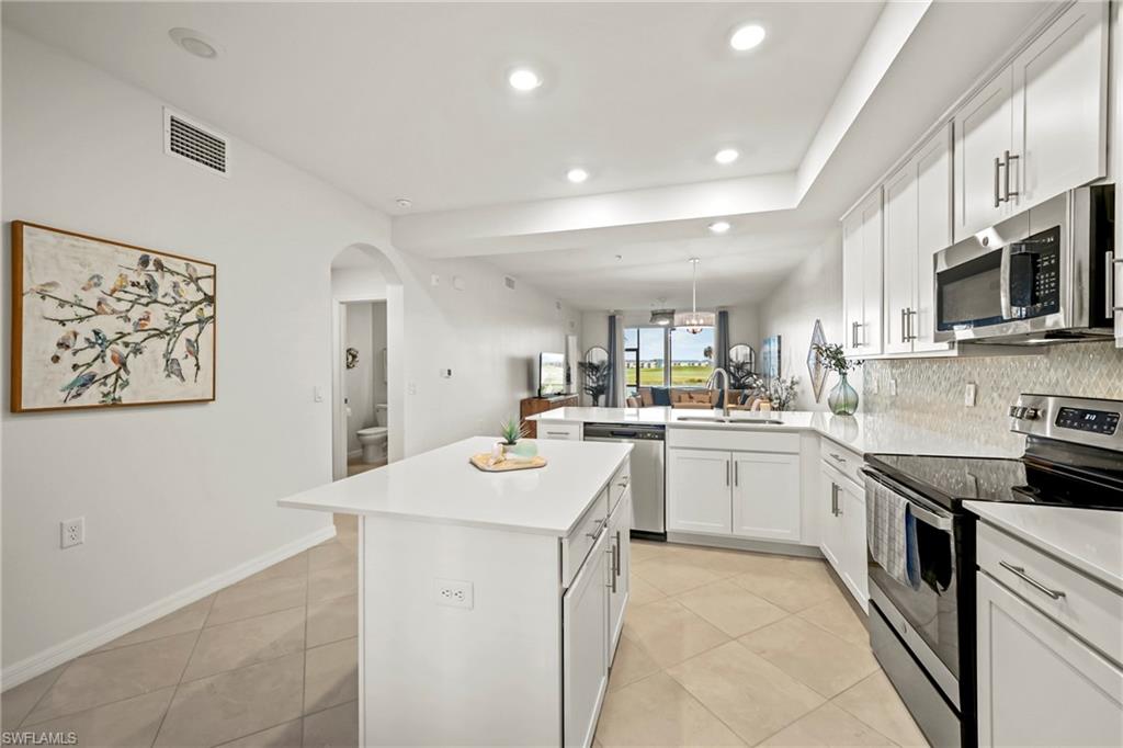 43993 Boardwalk Loop, Unit 1915 Babcock Ranch, FL 33982 - Photo 6 of 26 a kitchen with a sink appliances and cabinets