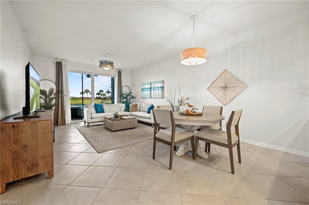 43993 Boardwalk Loop, Unit 1915 Babcock Ranch, FL 33982 - Photo 7 of 26 a living room with couches a dining table and a dining table with wooden floor