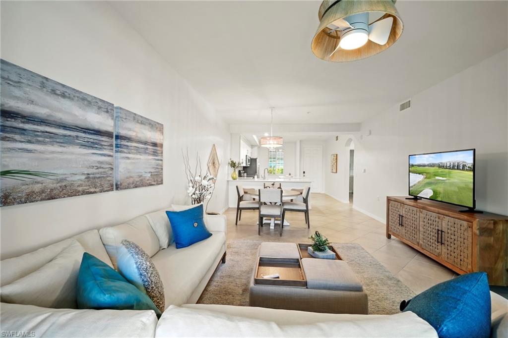 43993 Boardwalk Loop, Unit 1915 Babcock Ranch, FL 33982 - Photo 9 of 26 a living room with furniture wooden floor and a flat screen tv