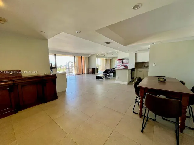 a kitchen with a sink and chairs