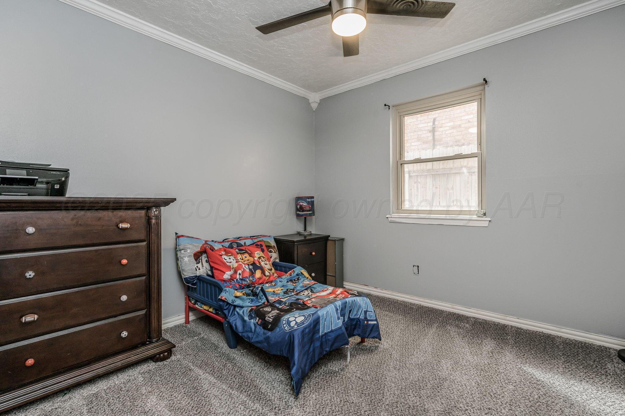 5326 Allen Street Amarillo, TX 79110 - Photo 11 of 17 a bedroom with a bed and a dresser