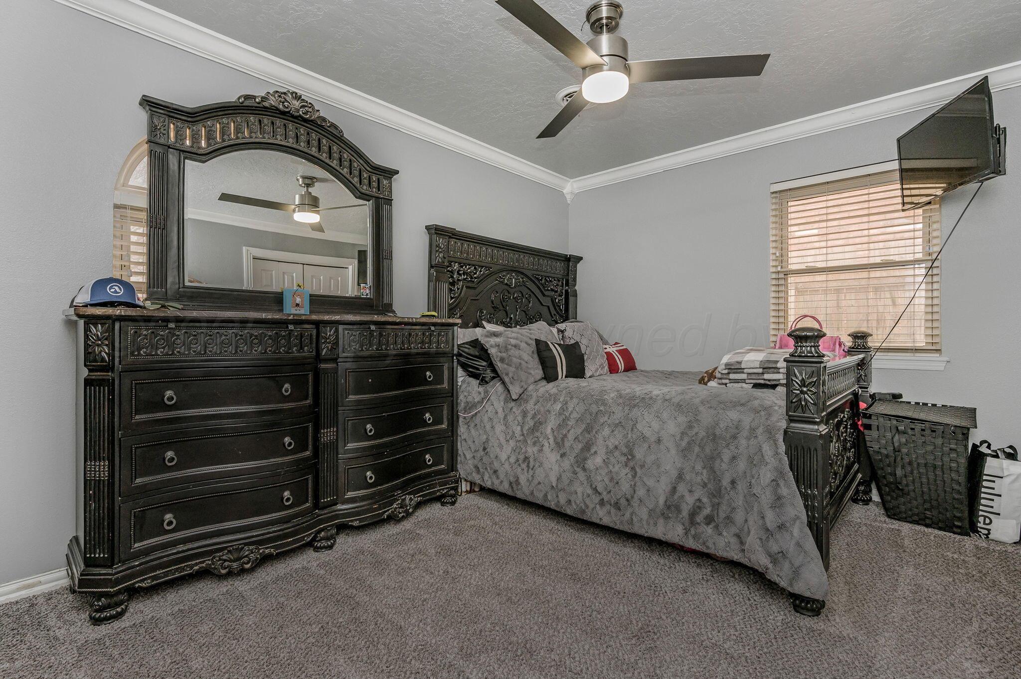 5326 Allen Street Amarillo, TX 79110 - Photo 13 of 17 a bedroom with a bed and a mirror on the dresser