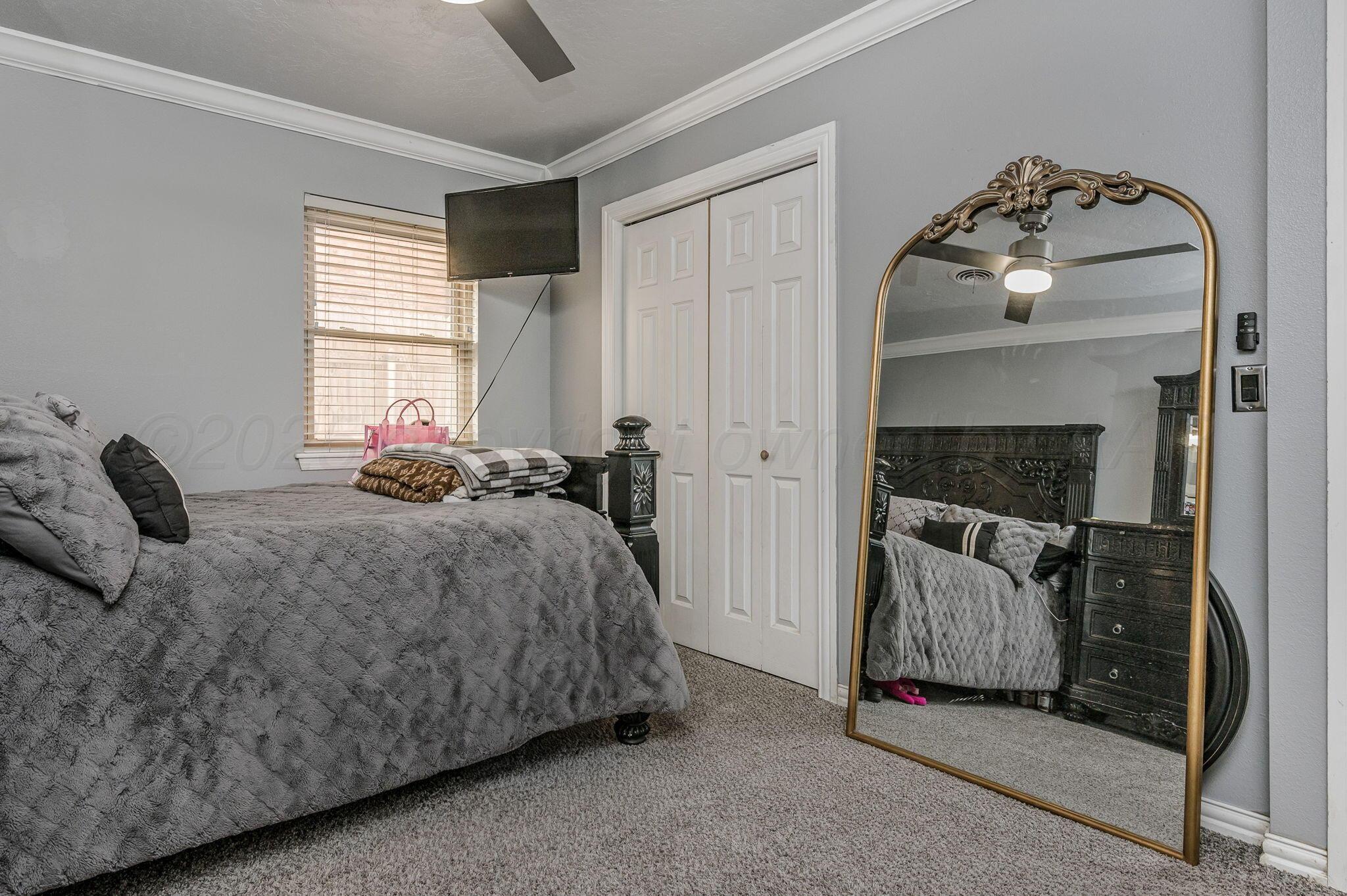 5326 Allen Street Amarillo, TX 79110 - Photo 15 of 17 a bedroom with a bed and a mirror