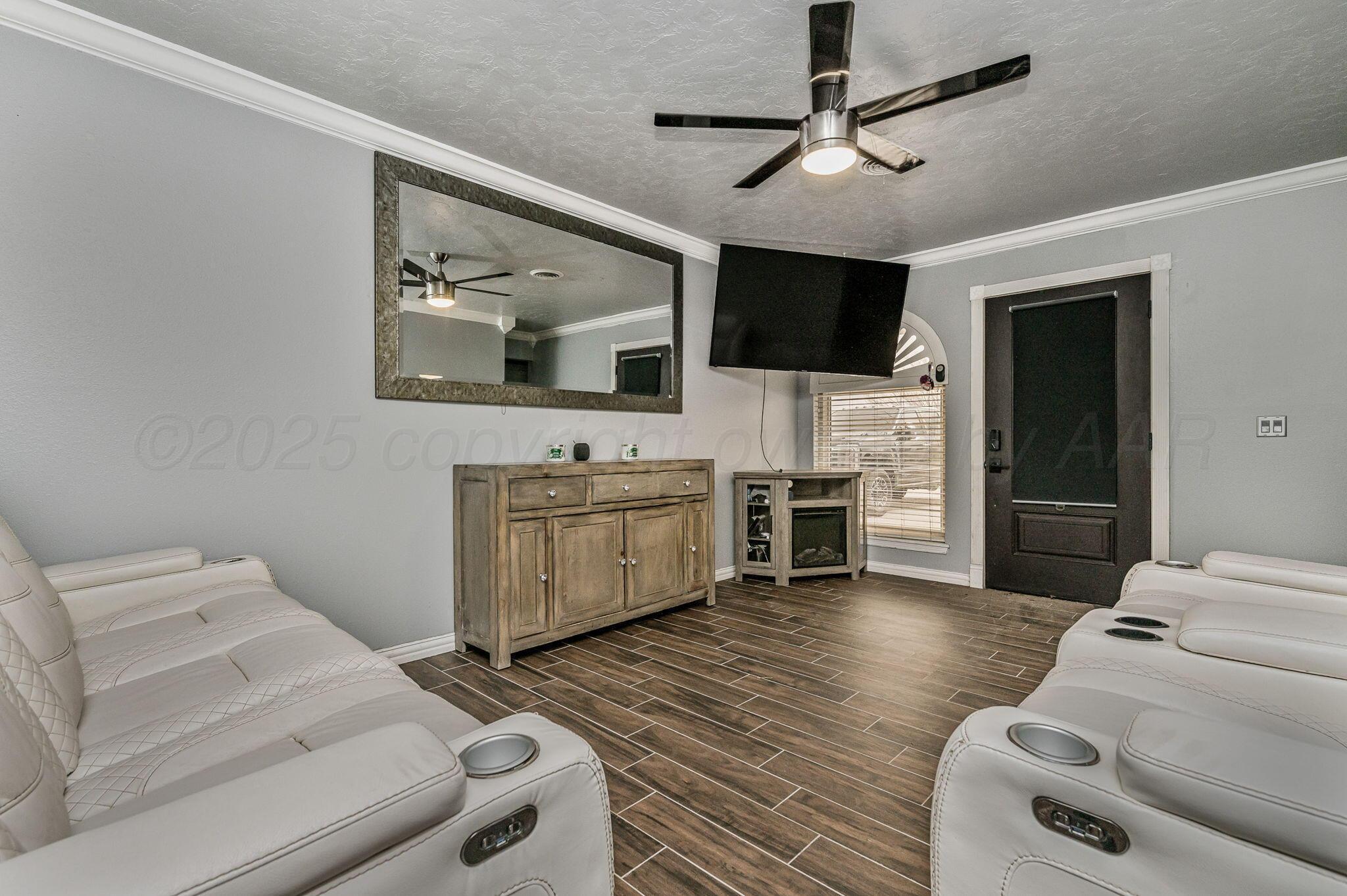5326 Allen Street Amarillo, TX 79110 - Photo 3 of 17 a living room with furniture and a flat screen tv