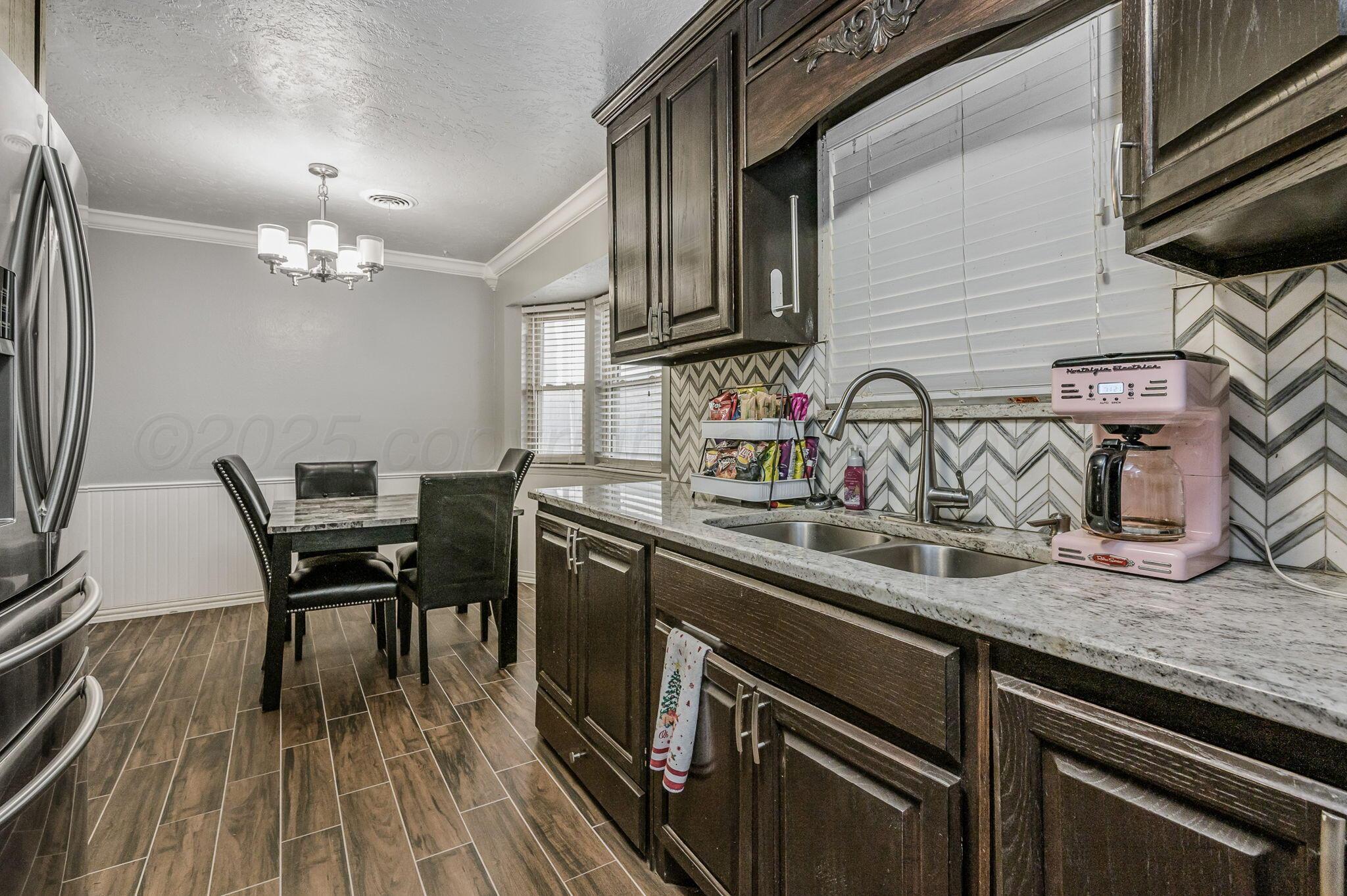 5326 Allen Street Amarillo, TX 79110 - Photo 7 of 17 a kitchen with a table chairs and wooden floor