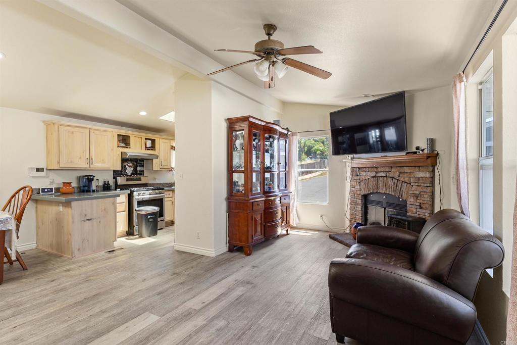12044 Royal Road, Unit 121 El Cajon, CA 92021 - Photo 3 of 26 a living room with furniture fireplace and flat screen tv