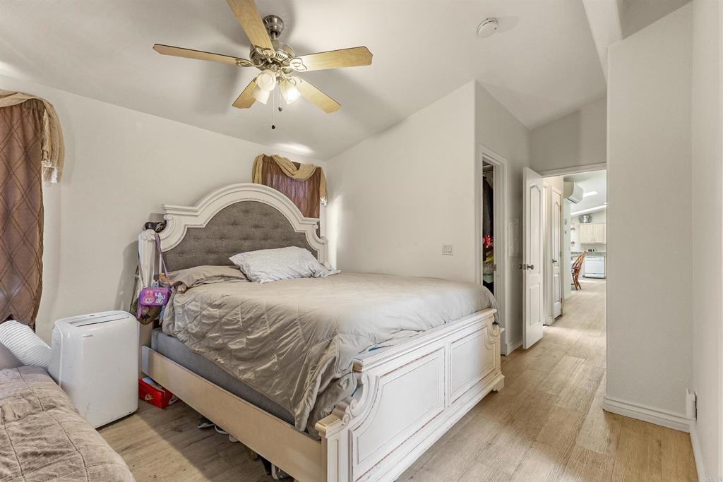 12044 Royal Road, Unit 121 El Cajon, CA 92021 - Photo 4 of 26 a bedroom with a bed and a chandelier
