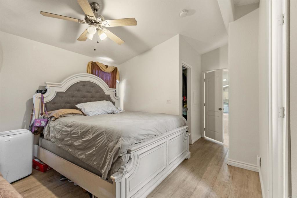 12044 Royal Road, Unit 121 El Cajon, CA 92021 - Photo 5 of 26 a bedroom with a bed and a chandelier