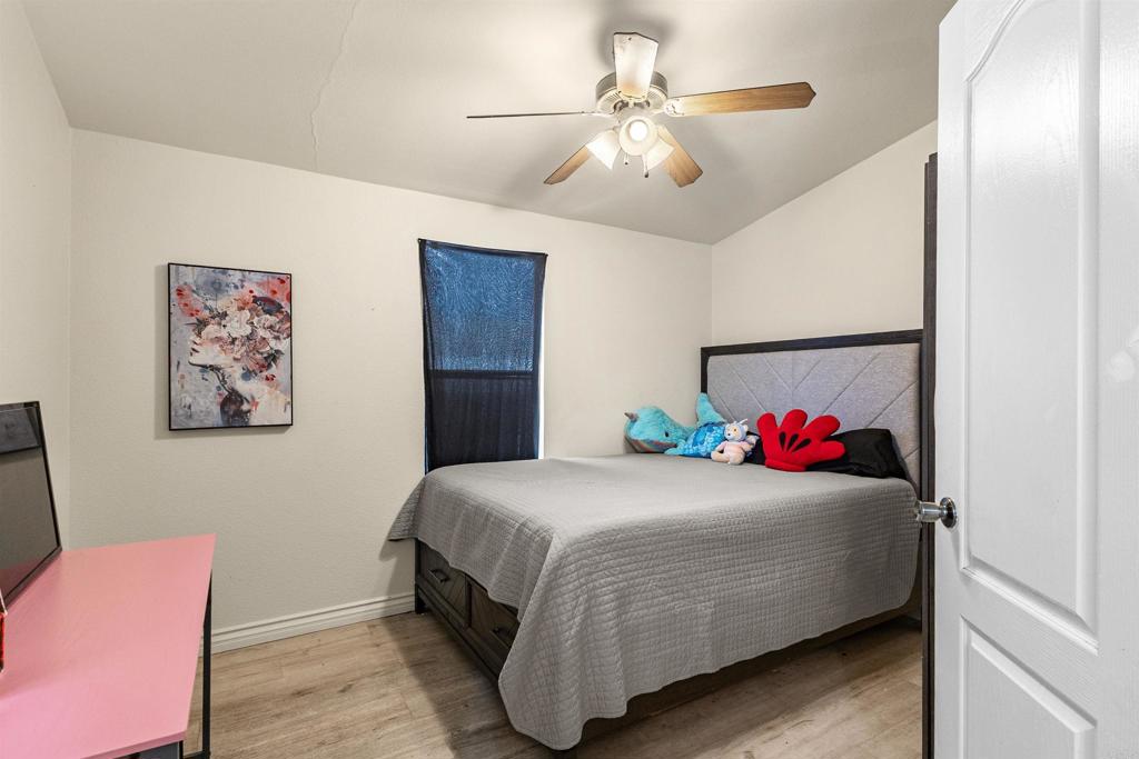 12044 Royal Road, Unit 121 El Cajon, CA 92021 - Photo 8 of 26 a bedroom with a bed and a chandelier