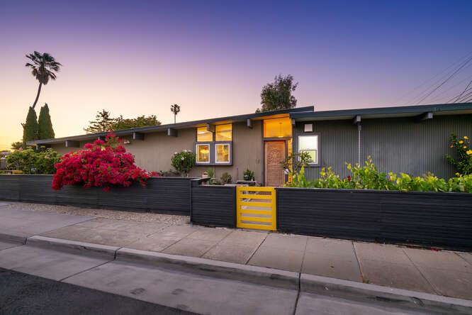 a front view of a house with a yard