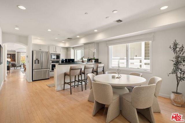 a kitchen with stainless steel appliances kitchen island granite top and refrigerator