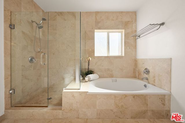 a bathroom with a granite countertop double vanity sink and a mirror