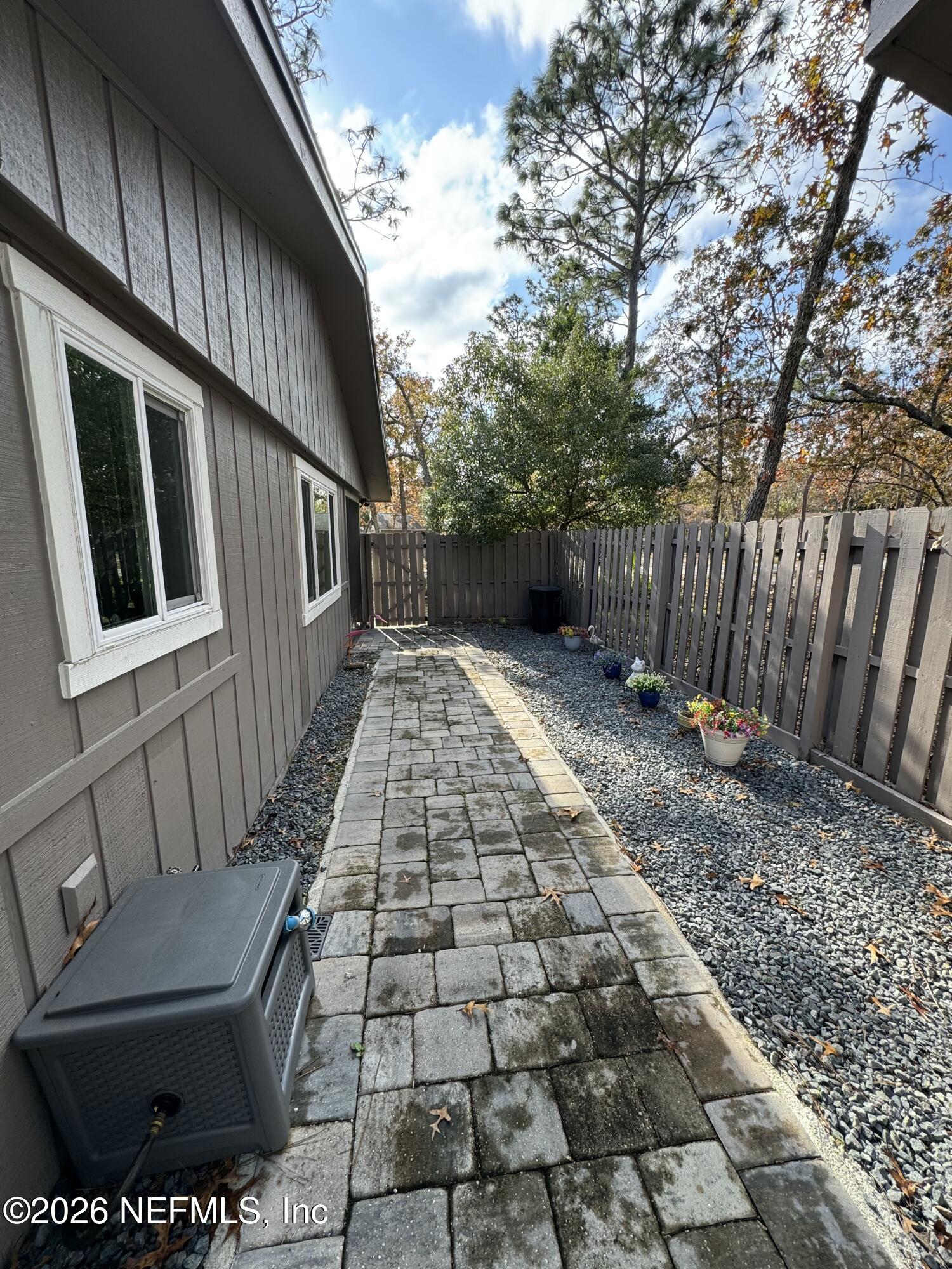 49 Cypress Pond Road Port Orange, FL 32128 - Photo 14 of 16 a view of backyard with barbeque grill and wooden fence