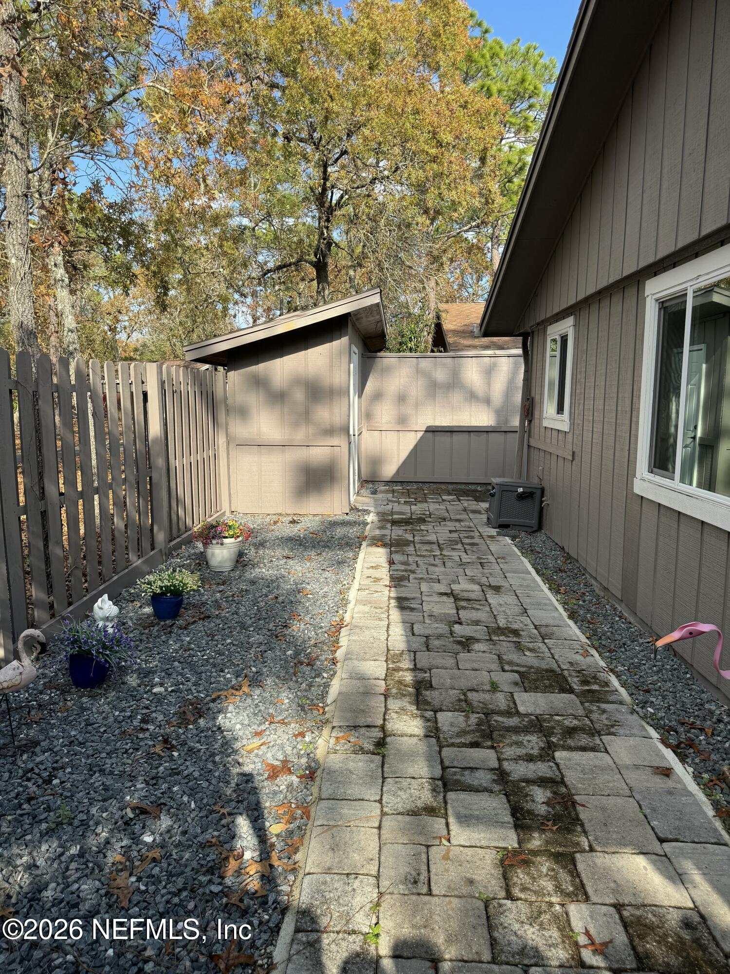 49 Cypress Pond Road Port Orange, FL 32128 - Photo 16 of 16 a backyard of a house with lots of green space and glass windows