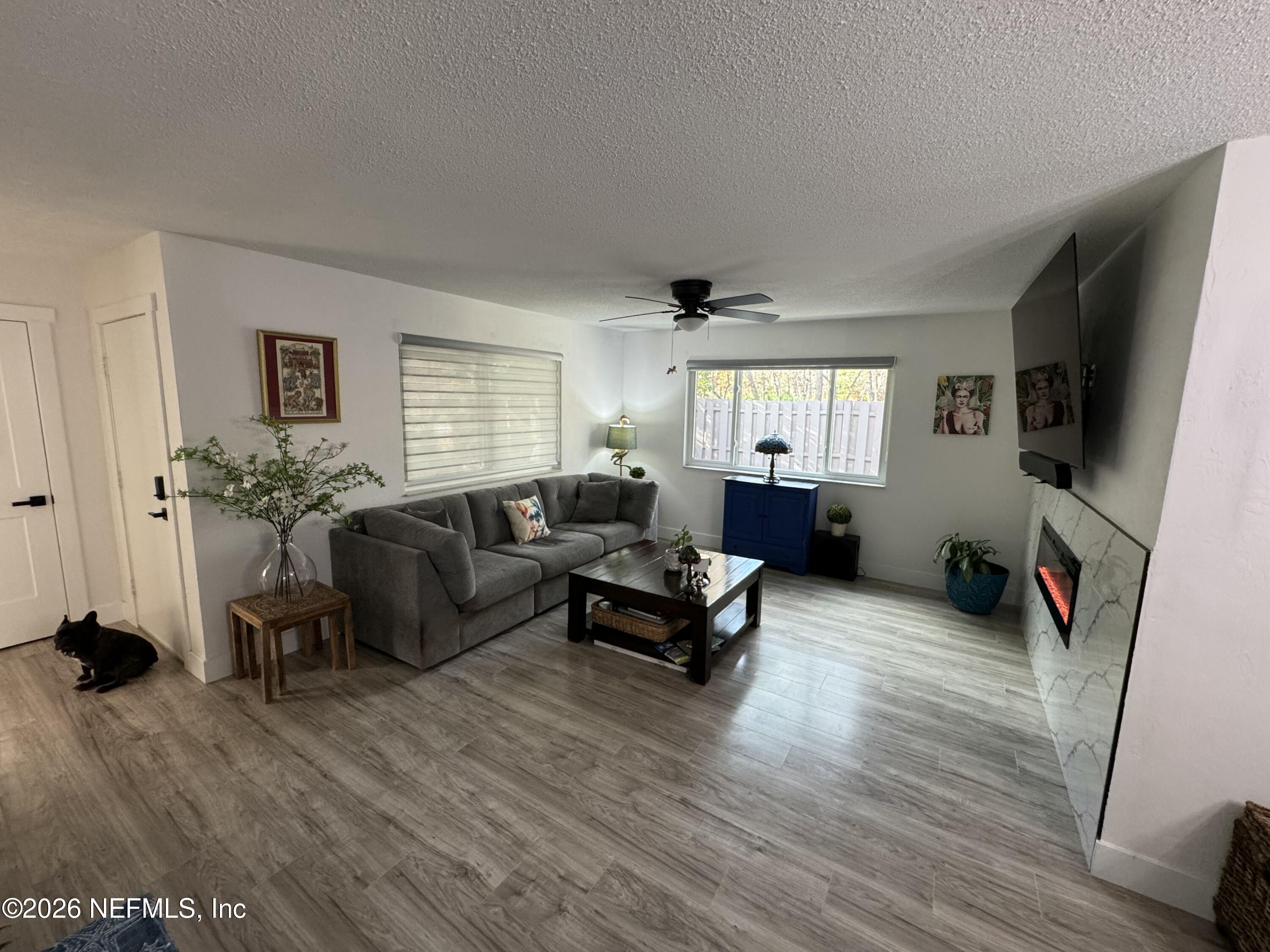 49 Cypress Pond Road Port Orange, FL 32128 - Photo 4 of 16 a living room with furniture and a flat screen tv