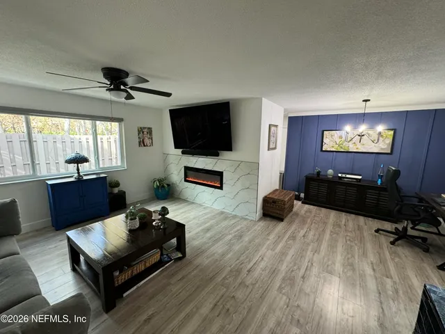 a living room with furniture and a flat screen tv