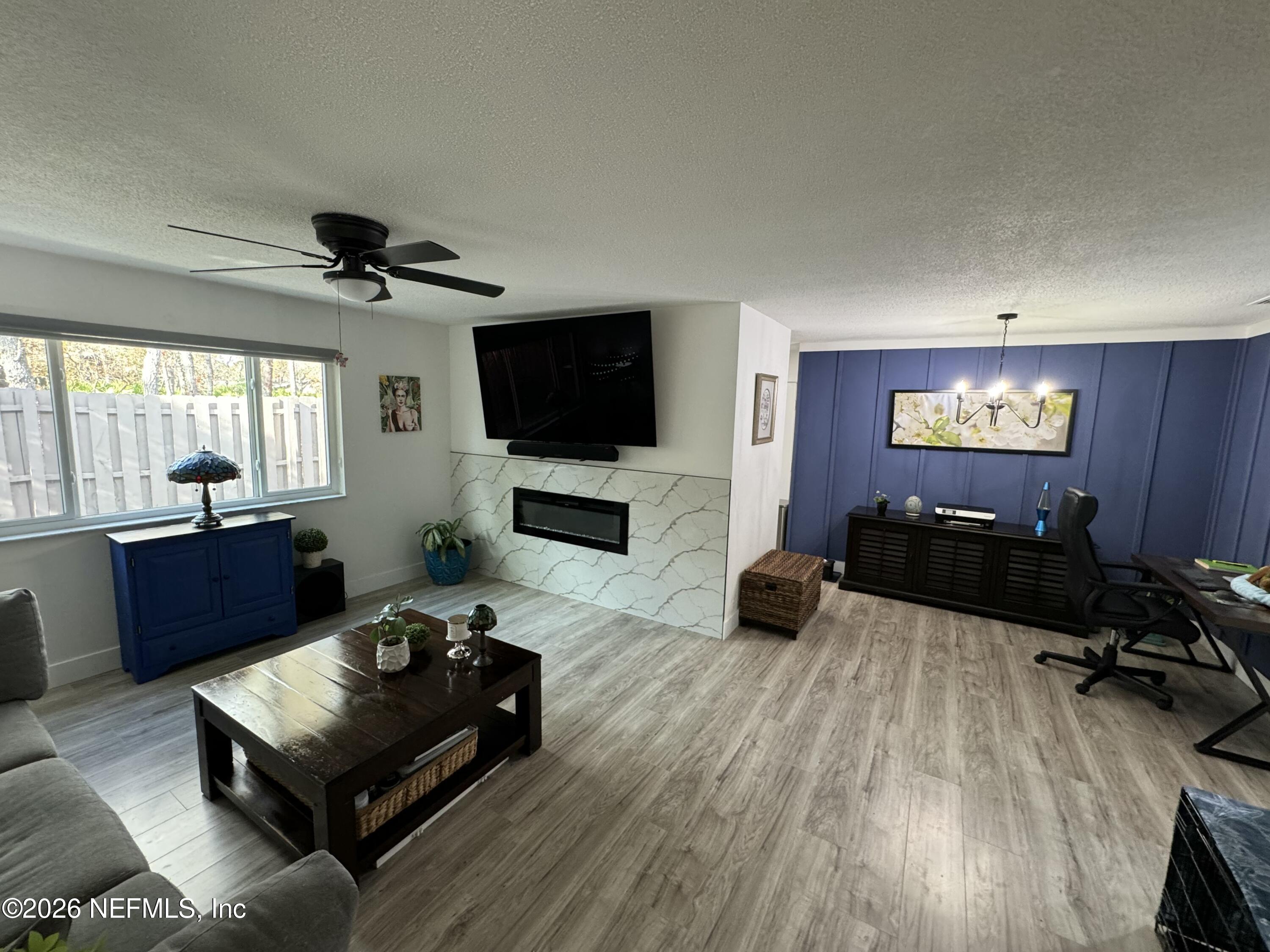 49 Cypress Pond Road Port Orange, FL 32128 - Photo 7 of 16 a living room with furniture and a flat screen tv