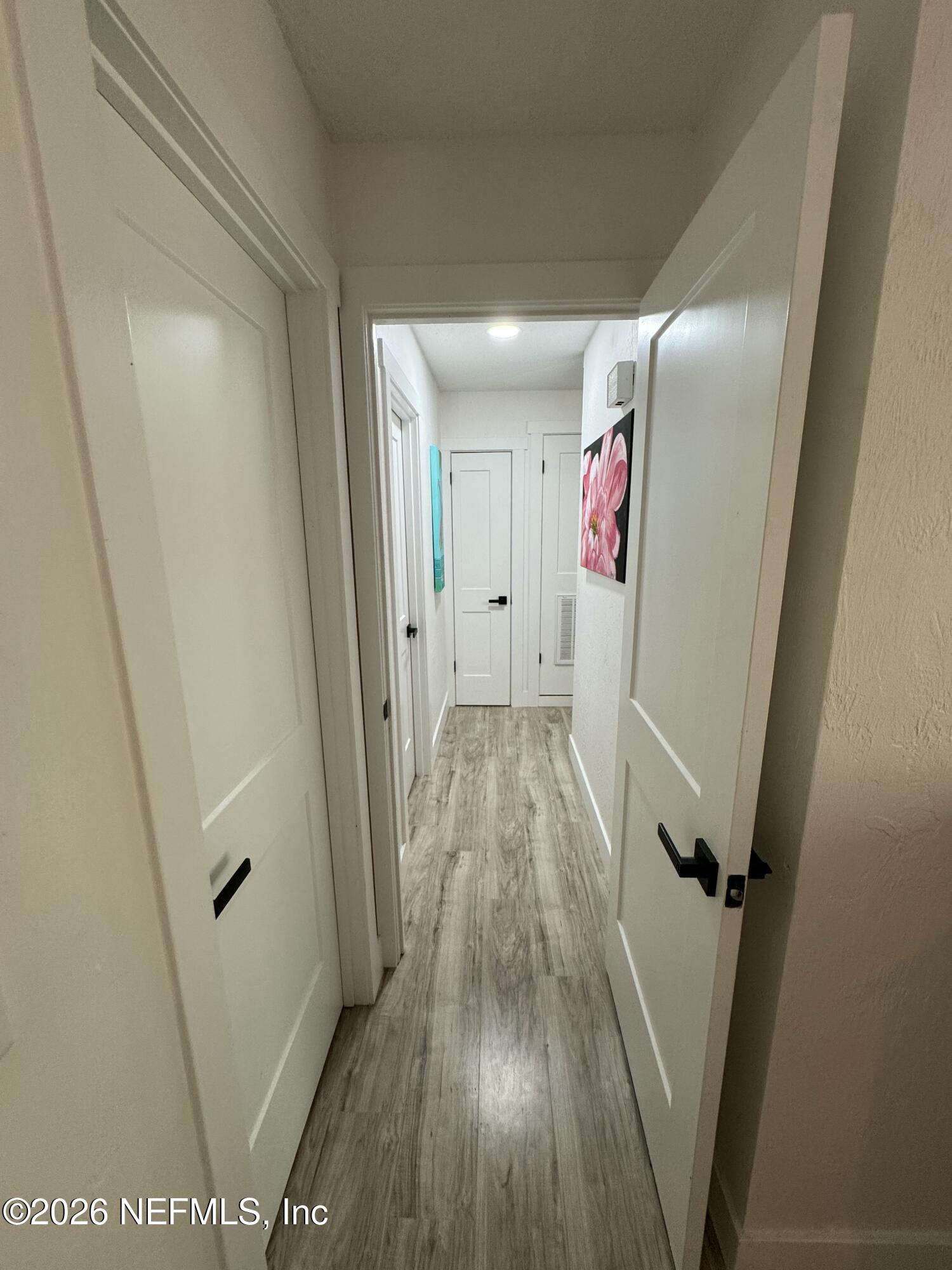 49 Cypress Pond Road Port Orange, FL 32128 - Photo 9 of 16 a view of a hallway with wooden floor and staircase